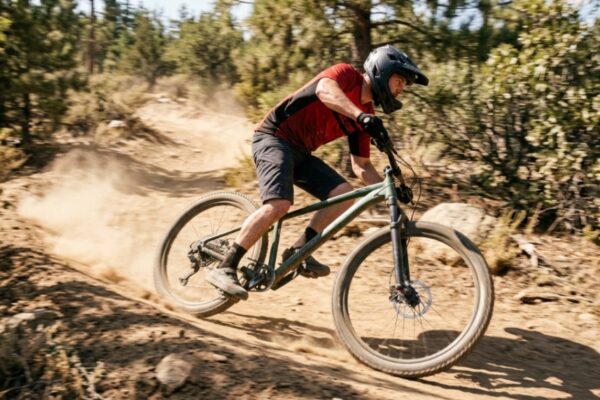 A reliable modern hardtail mountain bike parked on a scenic mountain dirt trail.